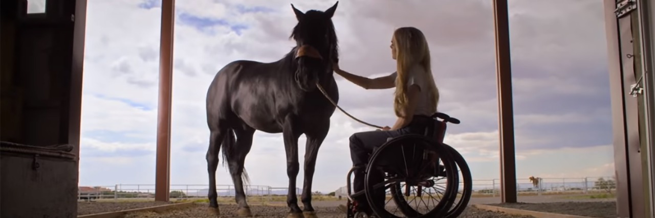 Woman in a wheelchair with horse, still from the Netflix film Walk. Ride. Rodeo. about rodeo barrel racer Amberley Snyder.