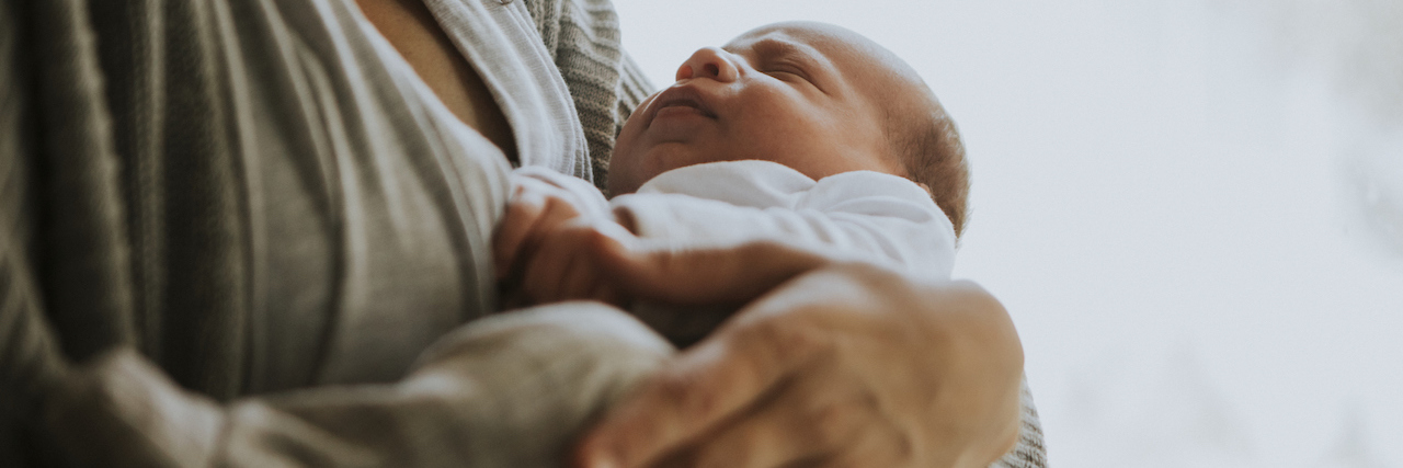 Recovering from Postpartum Depression and Feeling Like Me Again Mother holding her baby