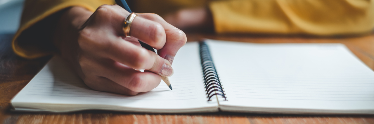 Talking to Parents of Healthy Kids When Your Child Is Sick woman writing in a notebook with a pencil