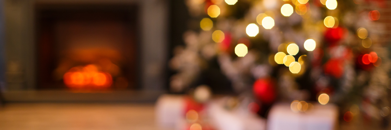 blurred photo of a home decorated for christmas fireplace and trees