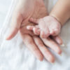 a mother and a baby's hands
