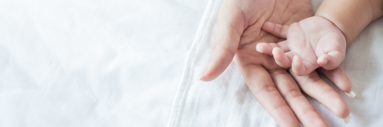 5 Motherhood Realities New Moms May Face a mother and a baby's hands