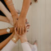 hands piled on top of one another to show support