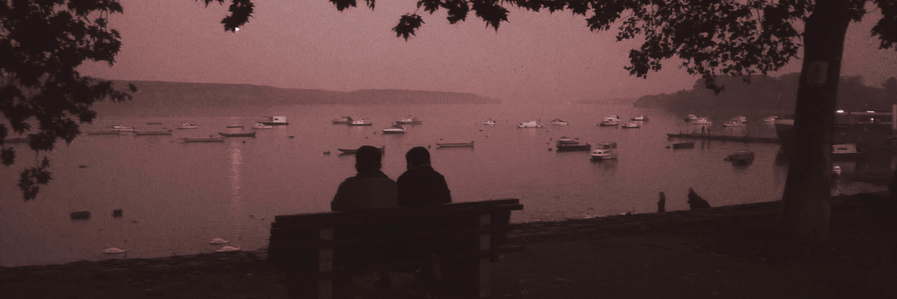 What to Say to Someone With Parkinson's Disease Two people sitting on bench.