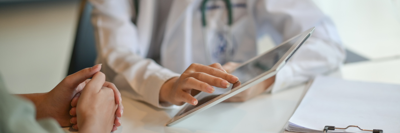 When Doctors Claim You're Lying About a Medical Disorder A doctor shows information to a patient.