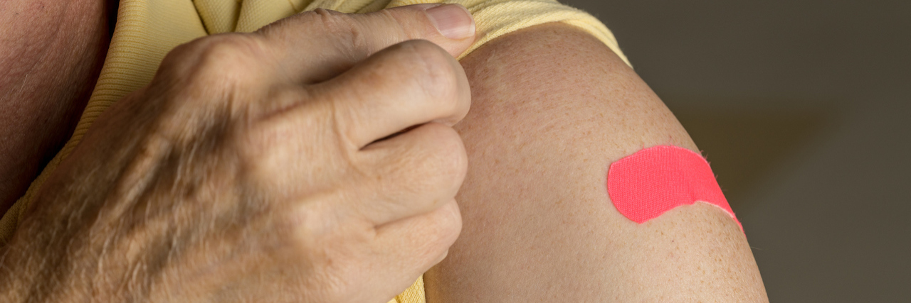 KHN: The Startlingly High Cost of the ‘Free’ Flu Shot Senior man holding up shirt after flu injection