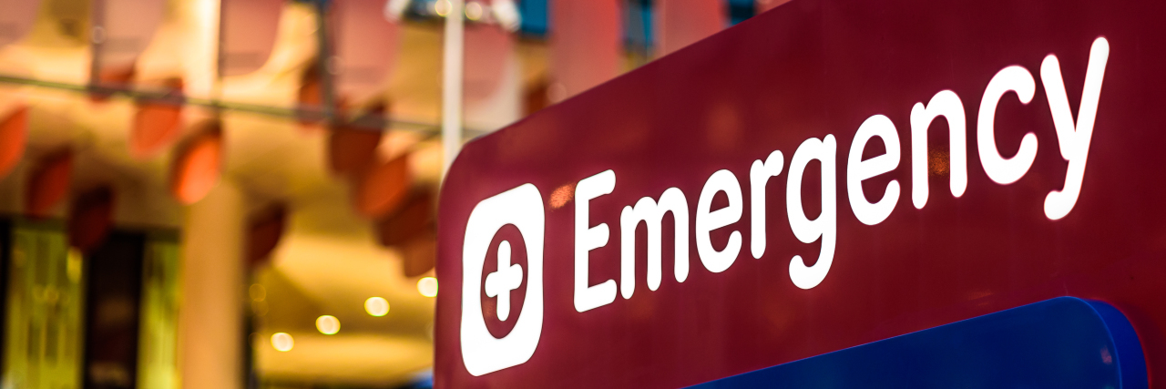 Most ER Staff Don't Understand Rare Disease, So This Is How I Advocate for Myself An "Emergency" Sign in front of a hospital in the early evening