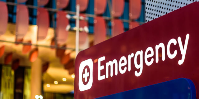 An "Emergency" Sign in front of a hospital in the early evening