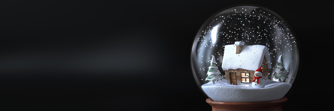 Don't Pity People With Disabilities Who Are Alone During the Holidays Snow globe with a cottage.