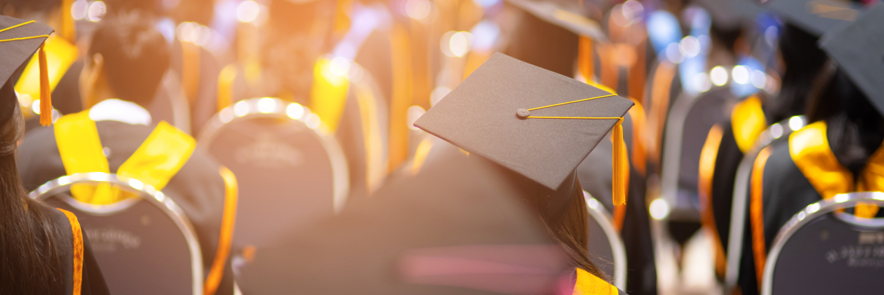 students in their graduation caps, sitting down