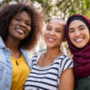 group of three women smiling, friends