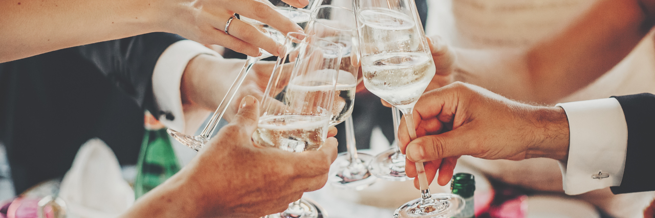 Hands toasting with champagne glasses, festive