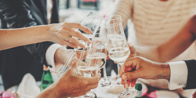 Hands toasting with champagne glasses, festive