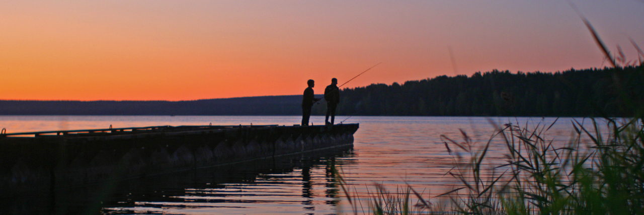 Living in the Moment When You Have Parkinson's Disease Father and son fishing from a wooden pier.