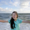 Girl with Down syndrome at the beach.