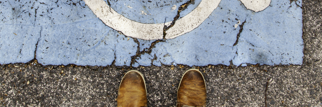 Vestibular Disorders Are Invisible Disabilities Disabled sign on asphalt.