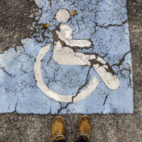 Disabled sign on asphalt.