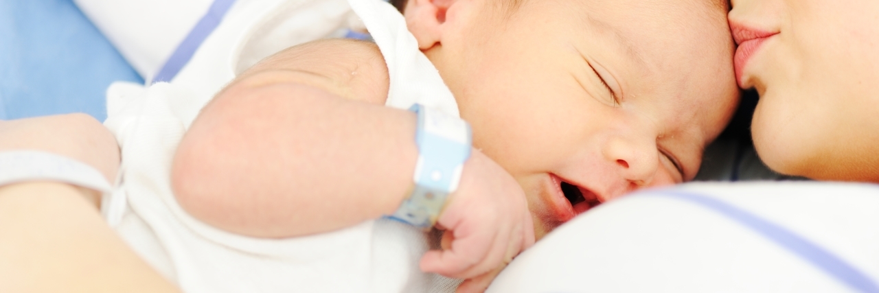 Preparing for Medical Crises When Your Child Is Sick woman holding her baby in the hospital