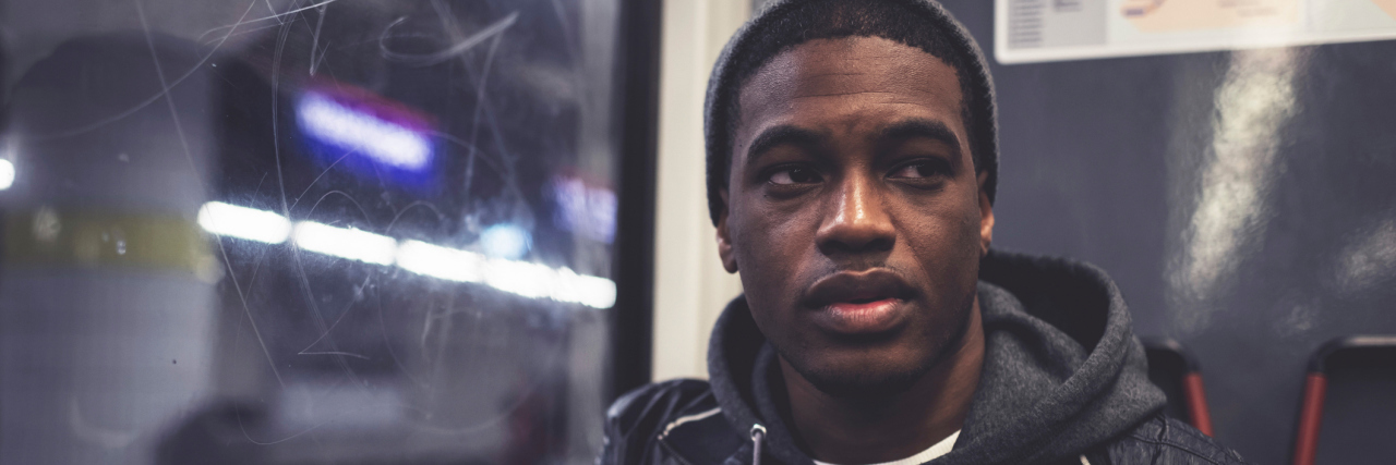 5 Pieces of Advice for Anyone Recently Diagnosed With Bipolar Disorder A man sits alone on a train with a serious face.