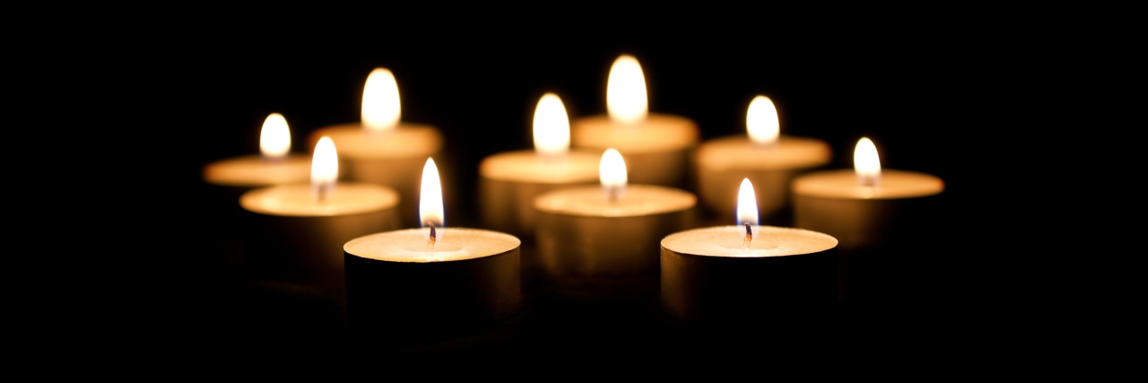 Burning candles on a black background.