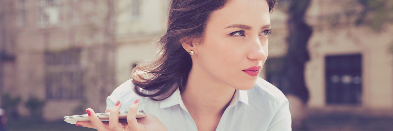 The 'Positive' Comments That Don't Help When You're Chronically Ill a frustrated woman holding a phone