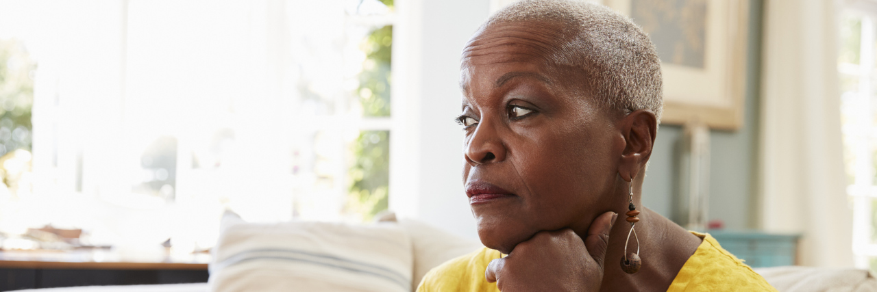 Learning Grief Counseling Techniques Senior Woman Sitting On Sofa At Home