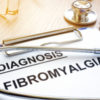 Clipboard with "diagnosis fibromyalgia" written.