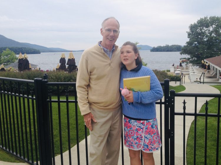 A teenage girl is standing with her late grandfather