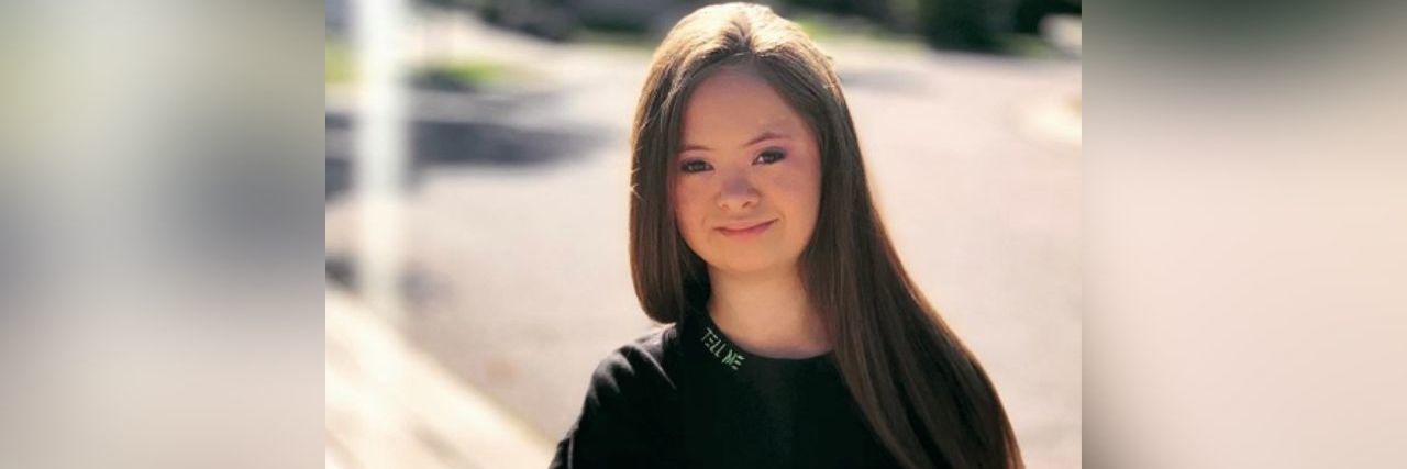 Meet Kennedy Garcia, a Model With Down Syndrome Kennedy Garcia wearing a long-sleeve black shirt with the words, "I am a personal, not a label" printed on the sleeves