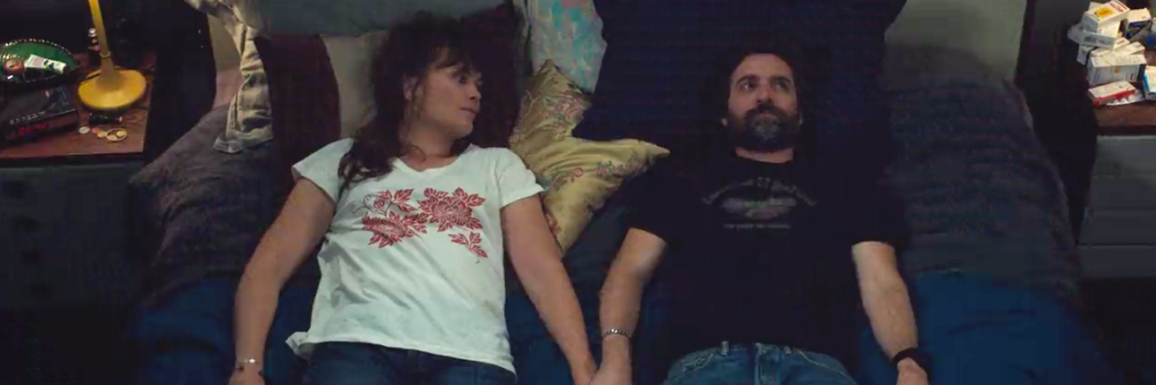 Netflix's 'Mythomaniac' Is About Faking Cancer for Personal Gain Scene from Netflix series 'Mythomaniac' showing white heterosexual couple lying in bed holding hands