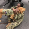 Brelahn Wyatt, a second-year medical student, hugs Shetland, a half-golden retriever, half-Labrador retriever who also happens to be a lieutenant commander in the Navy and a clinical instructor in the Department of Medical and Clinical Psychology at the Uniformed Services University of the Health Sciences. (Julie Rovner/KHN)