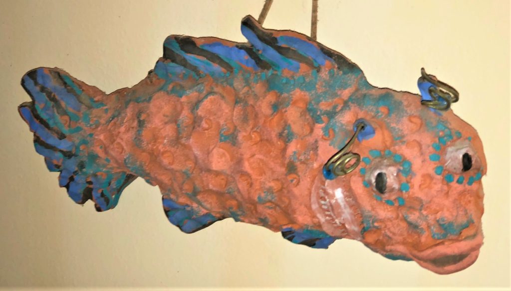 photo of orange and blue fish decoration on wall