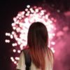 photo of woman silhouetted by fireworks