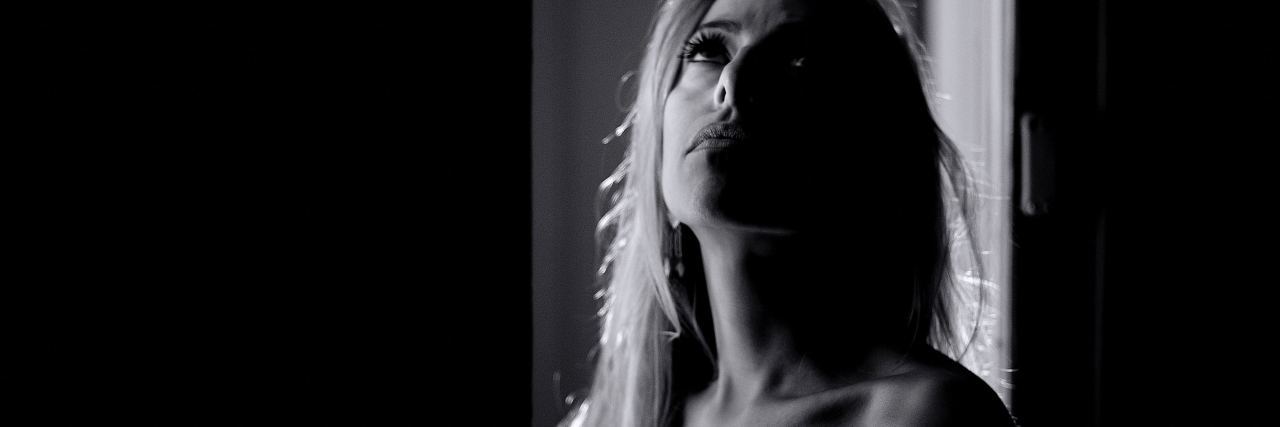 I Still Cry About My Brain Injury, Despite My Recovery Progress black and white photo of woman looking up at ceiling with sad expression