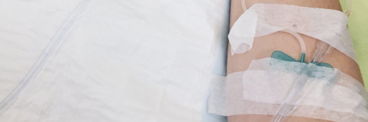 Reflections on Living 5 Years With Lyme Disease a woman's arm in a hospital bed with a needle