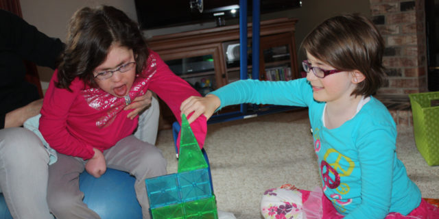 Finding Joy in Holiday Shopping for My Daughter With a Developmental Disability Michele's daughters playing together.