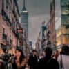 Blurry picture of a city with lots of people walking around