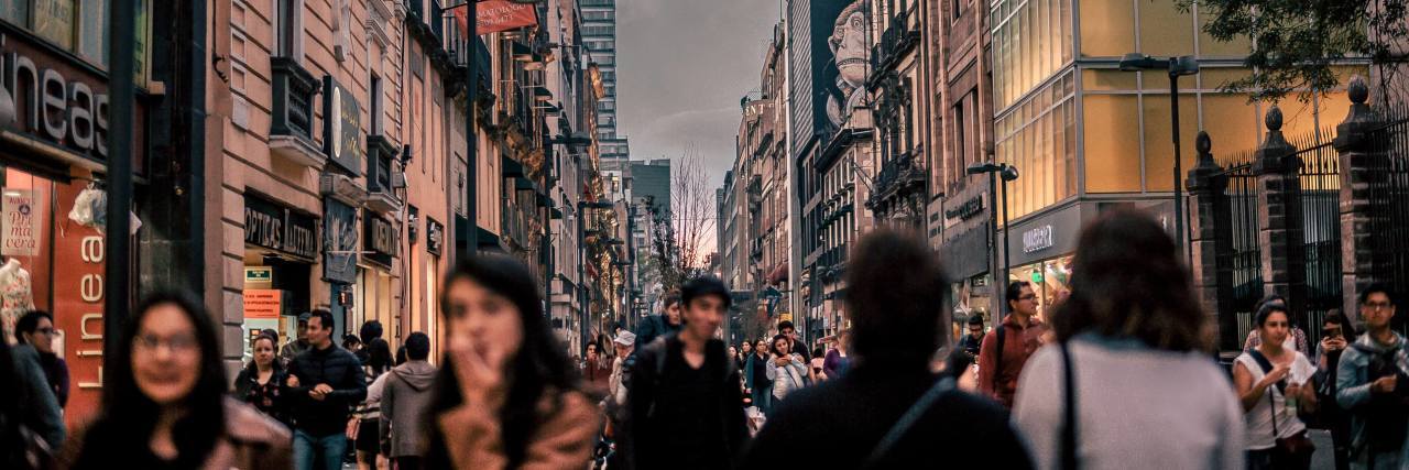 How I Use Pacing and Single-Tasking to Reduce Overwhelm and Anxiety Blurry picture of a city with lots of people walking around