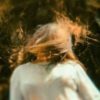 distorted photo of young woman with hair hiding her face