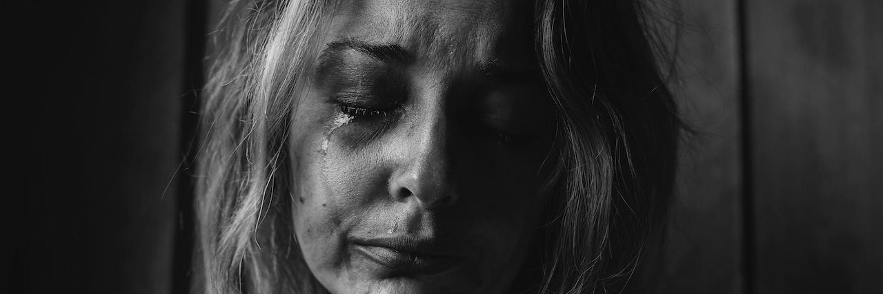 Grappling With Blame and Understanding in Daughter's Suicide Close up of a woman crying