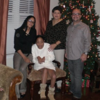 Tylia with her family by the Christmas tree.