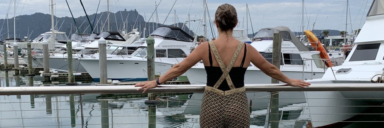 The Question I Struggle With During Encephalitis Recovery Women looking out at boat anchored in a marina