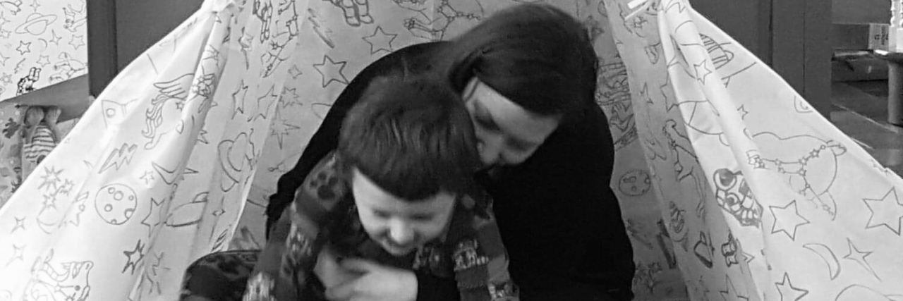 Responding to Rude Comments About Your Child on the Autism Spectrum Stephanie playing with her son in an indoor tent.