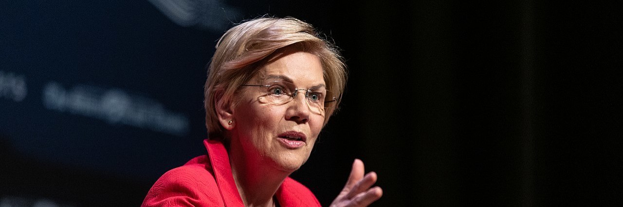 Why I Support Elizabeth Warren as Someone on the Autism Spectrum Elizabeth Warren sitting in a chair, speaking at a forum in Iowa.