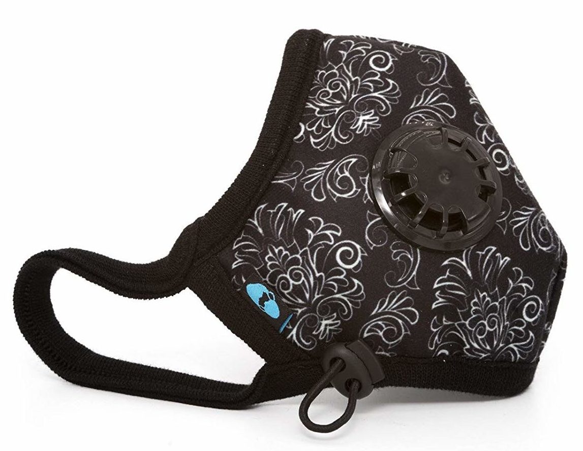 Black filtration mask with white filigree patterns.