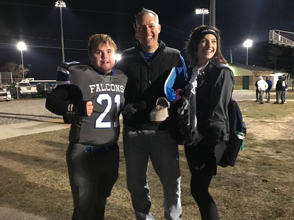 Caden Cox with his friend Mackenzie and her father, the famous 'Cheer Dad'