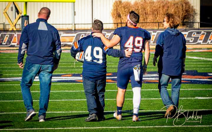 Caden's family. His dad on the left, Caden, his brother Zane, and his mom on the right. 