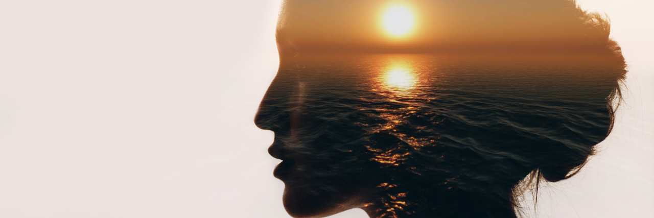 Woman silhouette with sunrise inside.
