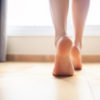 Woman bare feet walking on floor