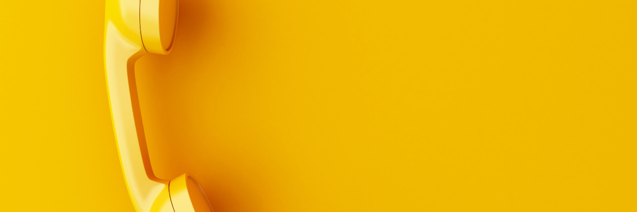 What's the Difference Between a 'Warmline' and a Suicide Hotline? intage phone reciever on yellow background.